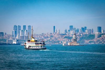 Sailboats in sea against clear sky