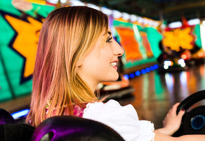 Happy woman enjoying in bumper cars