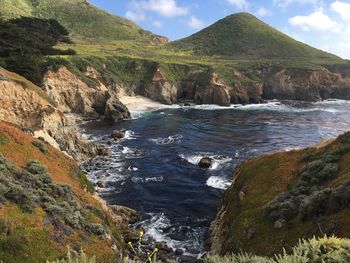 Scenic view of sea and mountains against sky