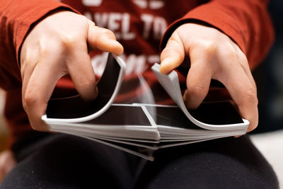 Close-up of boy playing with cards