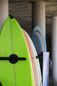 Set of surfboards of different colors in a pile.surfboards on the sandy beach for rent. 