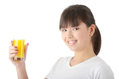 Portrait of a smiling young woman against white background