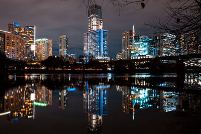 Reflection of illuminated buildings in city at night