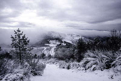 Scenic view of snow covered landscape against sky