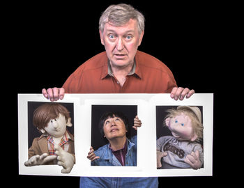 Portrait of happy friends against black background