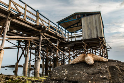 Abandoned metallic structure on land against sky