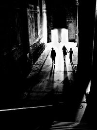 Rear view of silhouette people walking on stairs
