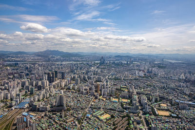 High angle view of illuminated city buildings against sky