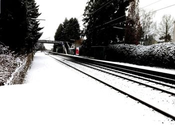 Railway tracks against clear sky during winter