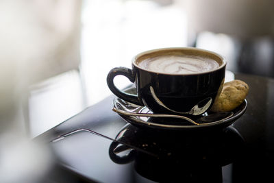 Close-up of coffee cup on table