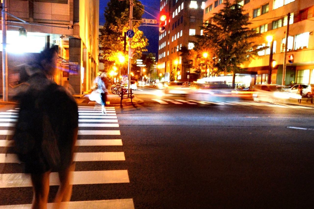 illuminated, city, street, building exterior, night, transportation, car, city street, land vehicle, city life, architecture, mode of transport, built structure, street light, road, incidental people, the way forward, walking, traffic