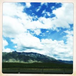 Scenic view of mountains against cloudy sky