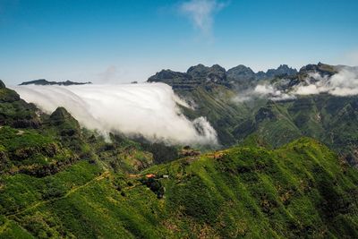 Scenic view of landscape against sky with clouds fog