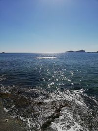 Scenic view of sea against clear blue sky