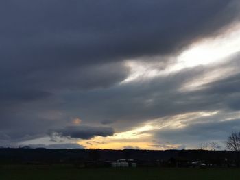 Scenic view of field against sky during sunset