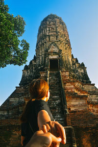 Rear view of man looking at temple