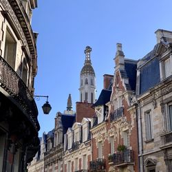 Low angle view of buildings against clear blue sky