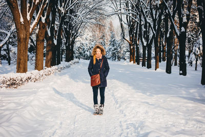 Full length of woman standing on snow