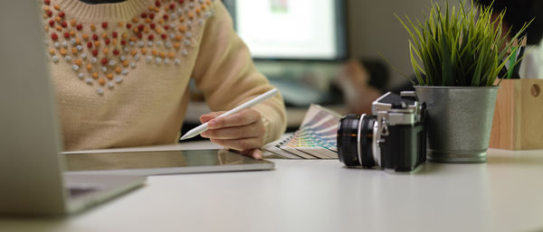 Midsection of woman working at desk