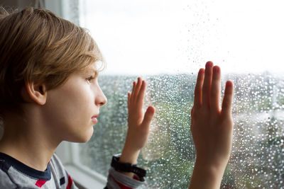 Side view of boy looking away at home