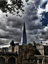 Low angle view of building against cloudy sky