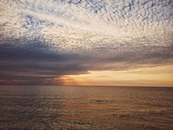 Scenic view of sea against cloudy sky