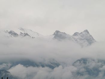 Low angle view of snowcapped mountains against sky