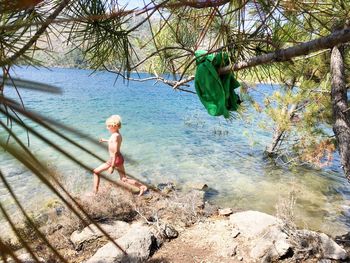 Boy wading into water