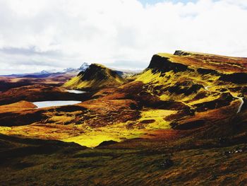 Scenic view of landscape against cloudy sky