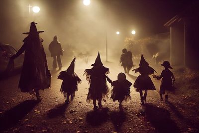 People walking on street at night