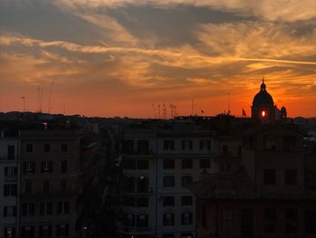 Silhouette buildings against sky during sunset