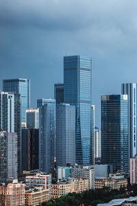 Modern buildings in city against sky