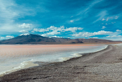 View of desert against cloudy sky