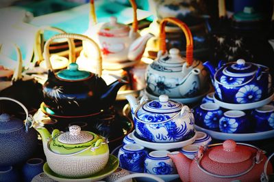 Close-up of colorful teapots for sale at street market