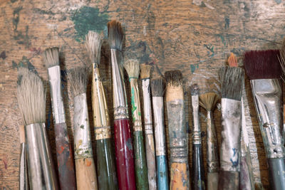 Variety of messy paintbrushes on table
