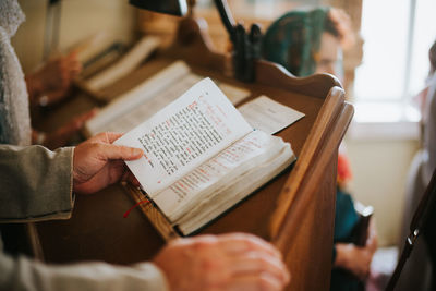 Midsection of woman reading book