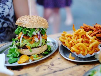 Close-up of burger and french fries in plate on table