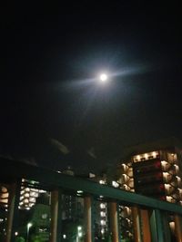 Low angle view of illuminated buildings against sky at night