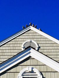 Low angle view of modern building against clear blue sky