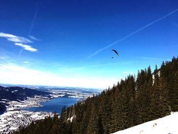 Scenic view of snow covered mountains against blue sky