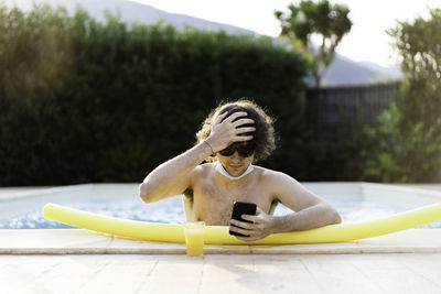 Full length of shirtless boy in swimming pool