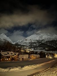 Scenic view of snowcapped mountains against sky at night