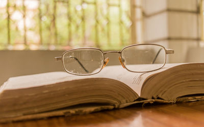 Close-up of eyeglasses on book