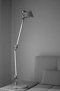 Low angle view of electric lamp against wall