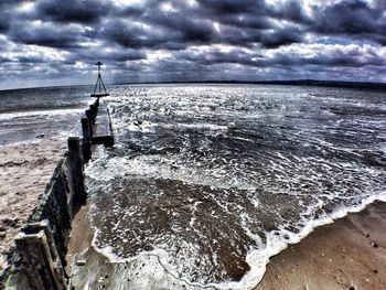 Scenic view of sea against cloudy sky