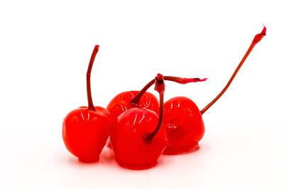 Close-up of red chili peppers against white background