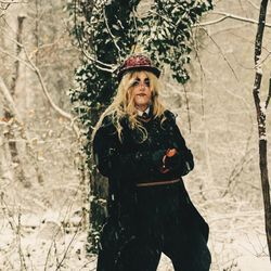 Woman standing in snow covered land