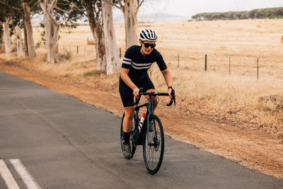 Woman riding bicycle on road