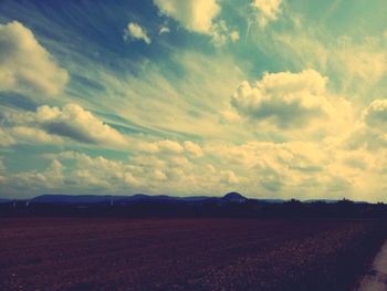 Scenic view of landscape against cloudy sky