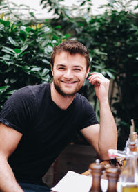 Portrait of young man sitting outdoors